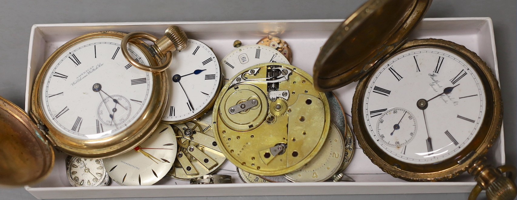 A gold plated Waltham hunter pocket watch, one other gold plated pocket watch and a small group of wrist and pocket watch movements.